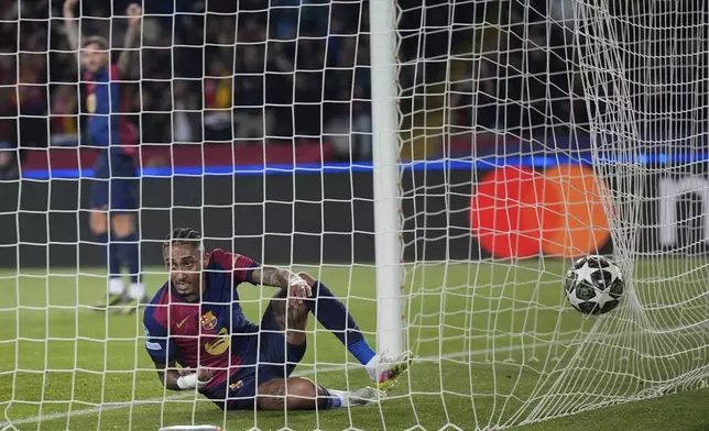 Barcelona's Raphinha scores his side's opening goal during the Champions League quarterfinal first leg soccer match between Barcelona and Borussia Dortmund, at the Lluis Companys Olympic stadium in Barcelona, Spain, Wednesday, April 9, 2025. (AP Photo/Emilio Morenatti)