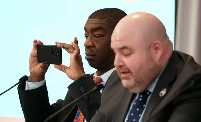 Commissioner Thomas Hicks takes a picture during the U.S. Election Assistance Commission Standards Board in-person public meeting, Thursday, April 24, 2025, in Charlotte, N.C. (AP Photo/Chris Carlson)