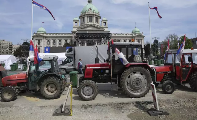 Tractors are parked in front of the Serbian parliament building ahead of a big counter-opposition protest rally planned to be staged over the weekend in downtown Belgrade, Serbia, Friday, April 11, 2025. (AP Photo/Darko Vojinovic)