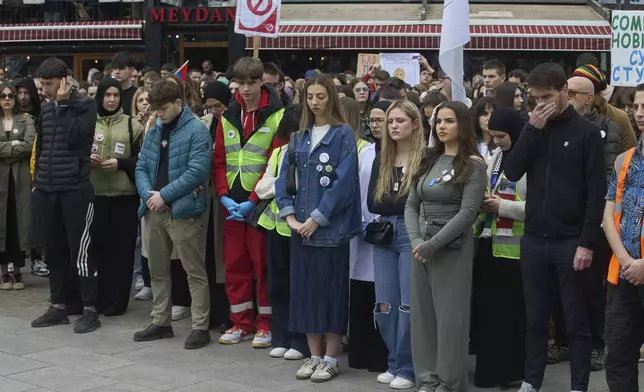 People observe seventeen minutes of silence during an anti-corruption protest in the southwestern town of Novi Pazar, Serbia, Saturday, April 12, 2025. (AP Photo/Marko Drobnjakovic)