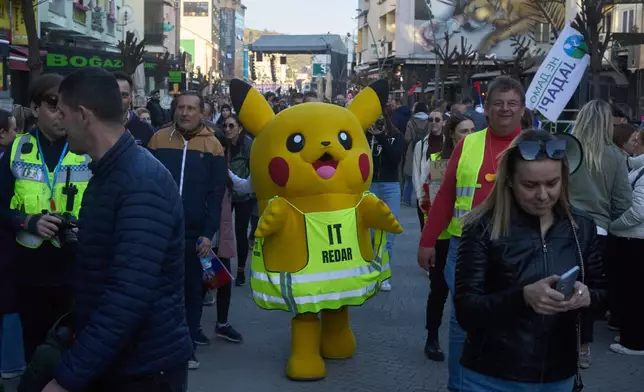A person dressed in a Pikachu costume walks during an anti-corruption protest led by university students in the southwestern town of Novi Pazar, Serbia, Saturday, April 12, 2025. (AP Photo/Marko Drobnjakovic)