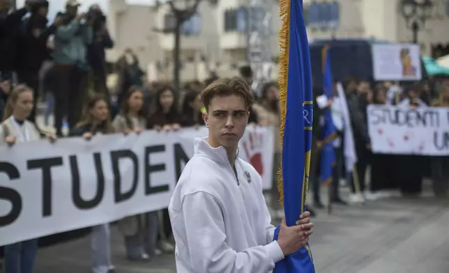 A student observes seventeen minutes of silence during an anti-corruption protest in the southwestern town of Novi Pazar, Serbia, Saturday, April 12, 2025. (AP Photo/Marko Drobnjakovic)