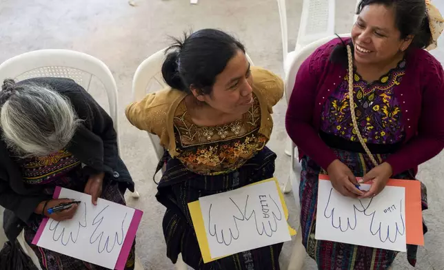 FILE - Indigenous women attend a support group during an event organized by the Jesuit Migrant Network that provides support to the relatives of migrants who died trying to reach the U.S. in Comitancillo, Guatemala, Monday, March 18, 2024. (AP Photo/Moises Castillo, File)