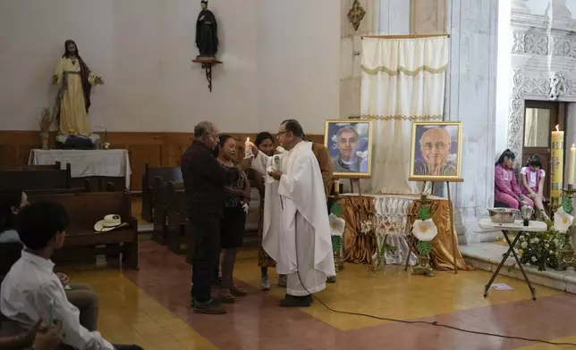 FILE - Rev. Jesus Reyes administers a baptism in the atrium of the Saint Francis Xavier Parish church in Cerocahui, Mexico, Sunday, May 12, 2024. (AP Photo/Eduardo Verdugo, File)