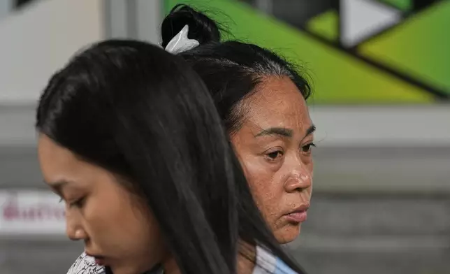 FILE - Naruemol Thonglek, right, with her daughter, waits for news of her partner, who is missing after the collapse of an under-construction high-rise building after an earthquake in Bangkok, Thailand, Monday, March, 31, 2025. (AP Photo/Manish Swarup, File)