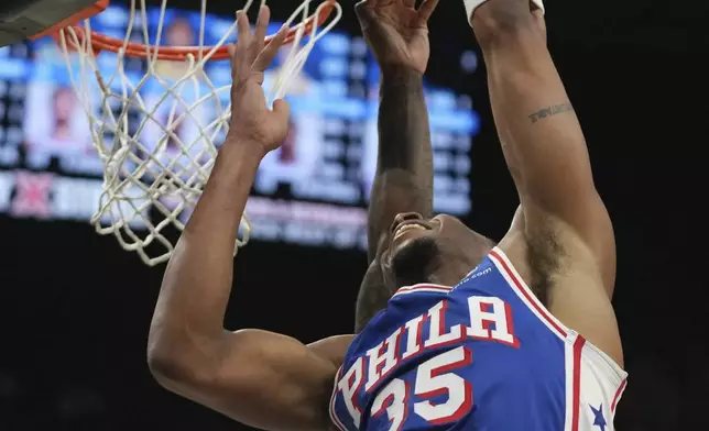 Philadelphia 76ers forward Marcus Bagley (35) attempts a dunk as Miami Heat guard Davion Mitchell (45) defends during the first half of an NBA basketball game, Monday, April 7, 2025, in Miami. (AP Photo/Lynne Sladky)