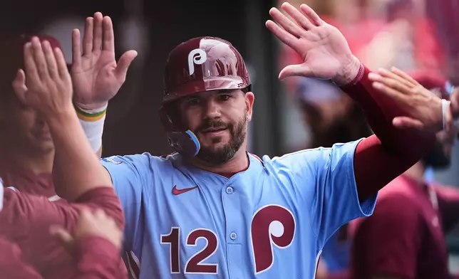 Philadelphia Phillies' Kyle Schwarber celebrates after scoring off of an RBI double hit by Bryce Harper during the fifth inning of a baseball game against the Colorado Rockies, Thursday, April 3, 2025, in Philadelphia. (AP Photo/Matt Rourke)