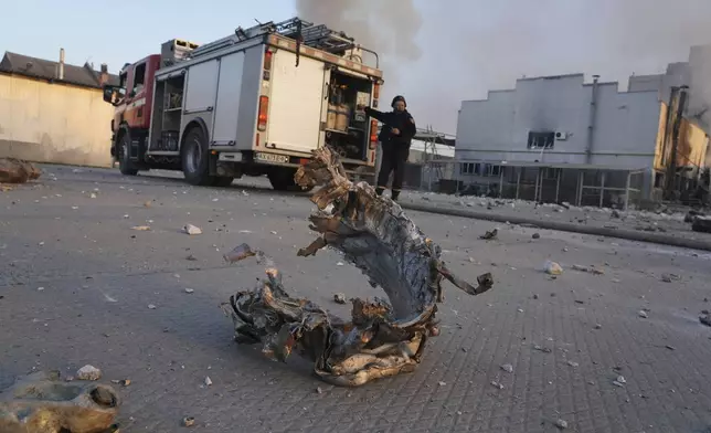 Part of a rocket lies on the floor in front of a perfume and cosmetics factory destroyed by a Russian strike in Kharkiv, Ukraine, Friday April 18, 2025. (AP Photo/Andrii Marienko)