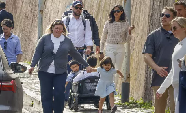 US Vice President J.D. Vance, center, leaves Rome's Botanic Gardens with his wife Usha, right, their daughter Mirabel holding hands with an unidentified staff member, front, and sons Vivek and Ewan, back to camera, Saturday, April 19, 2025. (AP Photo/Riccardo De Luca)