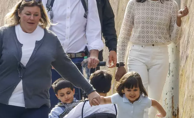 US Vice President J.D. Vance leaves Rome's Botanic Gardens with his wife Usha, right, their daughter Mirabel holding hand with an unidentified staff, front, and sons Vivek and Ewan, back to camera, Saturday, April 19, 2025. (AP Photo/Riccardo De Luca)