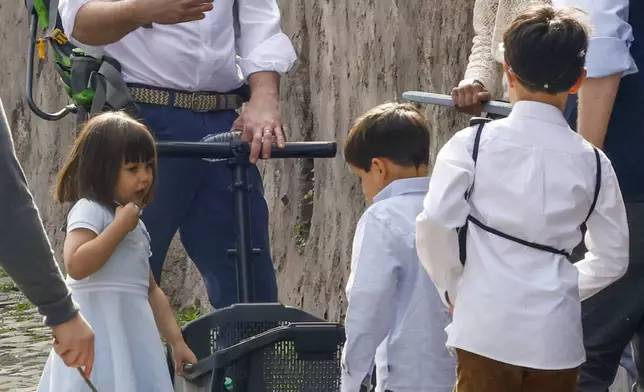US Vice President J.D. Vance leaves Rome's Botanic Gardens with his wife Usha, right, their daughter Mirabel, left, and sons Vivek and Ewan, back to camera, Saturday, April 19, 2025. (AP Photo/Riccardo De Luca)