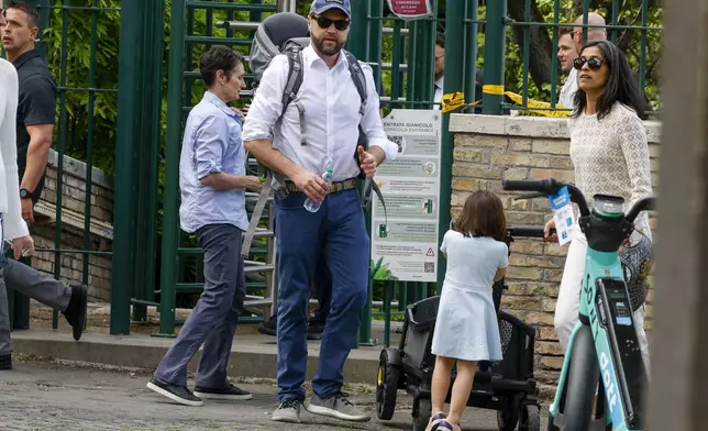 US Vice President J.D. Vance leaves Rome's Botanic Gardens with his wife Usha, right, and their daughter Mirabel, back to camera, Saturday, April 19, 2025. (AP Photo/Riccardo De Luca)
