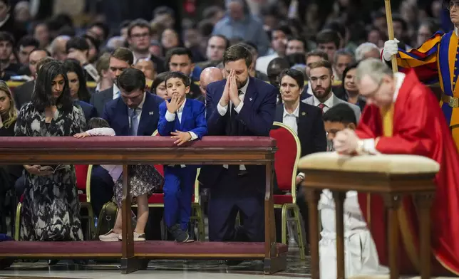 U.S. Vice President JD Vance, and his wife Usha Vance, left, with their daughter Mirabel, partially hidden, and son Vivek attend a Good Friday service led by Cardinal Claudio Gugerotti, right, inside St. Peter's Basilica at the Vatican, Friday, April 18, 2025. (AP Photo/Alessandra Tarantino)