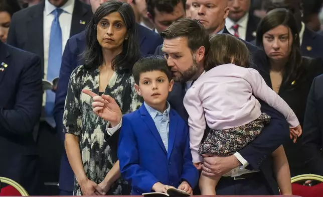 U.S. Vice President JD Vance, and his wife Usha Vance, left, with their daughter Mirabel, back to camera, and son Vivek attend a Good Friday service inside St. Peter's Basilica at the Vatican, Friday, April 18, 2025. (AP Photo/Alessandra Tarantino)