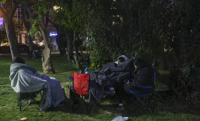 Locals rest in a public park following an earthquake shock with a preliminary magnitude of 6.2, in Istanbul, Turkey, Wednesday, April 23, 2025. (Berkman Ulutin/Dia Photo via AP)