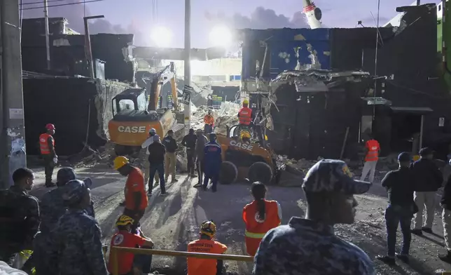 Rescue workers search for survivors at the Jet Set nightclub after its roof collapsed two nights prior during a merengue concert in Santo Domingo, Dominican Republic, Wednesday, April 9, 2025. (AP Photo/Ricardo Hernandez)
