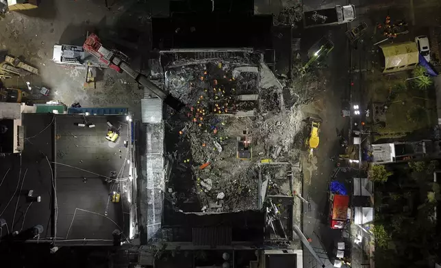 Rescue workers search for bodies at the Jet Set nightclub after its roof collapsed during a merengue concert in Santo Domingo, Dominican Republic, Thursday, April 10, 2025. (AP Photo/Matias Delacroix)