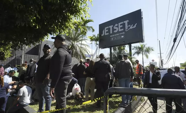 People gather outside the Jet Set nightclub after its roof collapsed during a merengue concert in Santo Domingo, Dominican Republic, Tuesday, April 8, 2025. (AP Photo/Ricardo Hernandez)