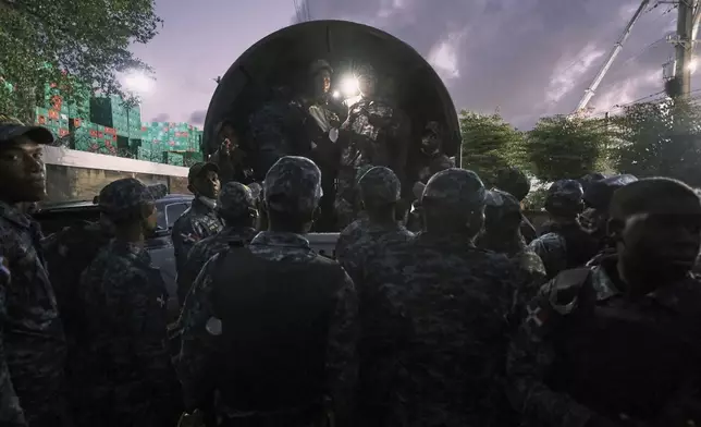 Soldiers prepare to assist with security during the rescue effort at Jet Set nightclub after its roof collapsed during a merengue concert in Santo Domingo, Dominican Republic, Wednesday, April 9, 2025. (AP Photo/Ricardo Hernandez)