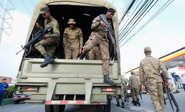 Soldiers arrive to the area where rescue workers search for survivors at the Jet Set nightclub after its roof collapsed two nights prior during a merengue concert in Santo Domingo, Dominican Republic, Wednesday, April 9, 2025. (AP Photo/Ricardo Hernandez)