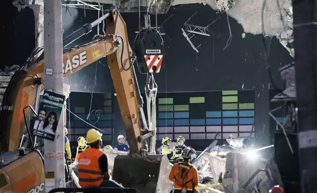 Rescue workers search for survivors at the Jet Set nightclub after its roof collapsed two nights before during a merengue concert in Santo Domingo, Dominican Republic, Wednesday, April 9, 2025. (AP Photo/Ricardo Hernandez)