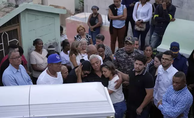 Family and friends attend the burial of Marilenny Pilarte who died at the Jet Set nightclub when its roof collapsed, in Haina, Dominican Republic, Thursday, April 10, 2025. (AP Photo/Matias Delacroix)
