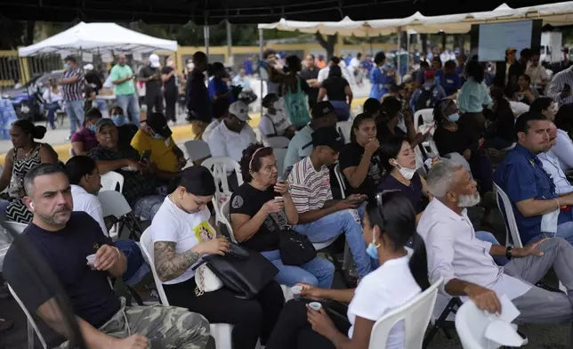 Family members wait to receive the remains of their loved one who died at the Jet Set nightclub days after its roof collapsed, killing more than 200 people, at the National Institute of Forensic Pathology in Santo Domingo, Dominican Republic, Friday, April 11, 2025. (AP Photo/Matias Delacroix)