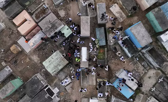 Family and friends attend the burial service for Marilenny Pilarte who died at the Jet Set nightclub when its roof collapsed, in Haina, Dominican Republic, Thursday, April 10, 2025. (AP Photo/Matias Delacroix)
