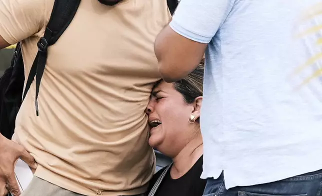 A woman cries during the search for survivors at the Jet Set nightclub after its roof collapsed two nights prior during a merengue concert in Santo Domingo, Dominican Republic, Wednesday, April 9, 2025. (AP Photo/Ricardo Hernandez)