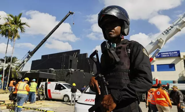 Police cordon off the area as rescue workers search for survivors at the Jet Set nightclub after its roof collapsed during a merengue concert in Santo Domingo, Dominican Republic, Tuesday, April 8, 2025. (AP Photo/Eddy Vittini)
