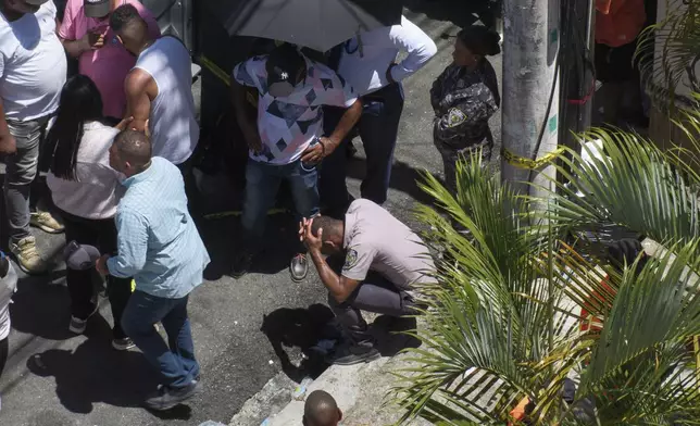 A police officer reacts during the search for survivors at the Jet Set nightclub after its roof collapsed during a concert in Santo Domingo, Dominican Republic, Tuesday, April 8, 2025. (AP Photo/Ricardo Hernandez)