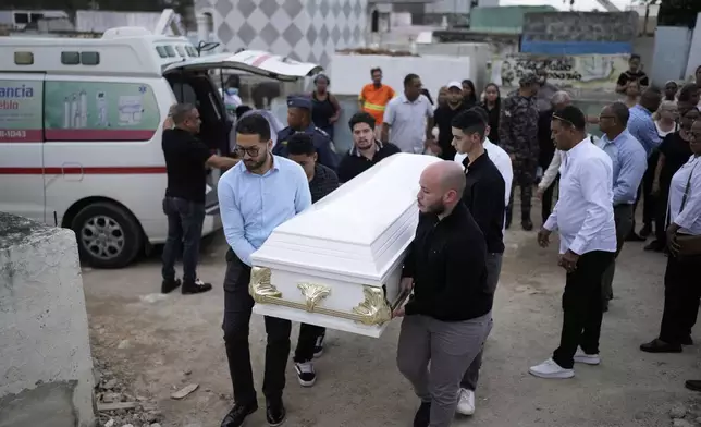 Relatives carry the coffin that contain the remains of Marilenny Pilarte who died at the Jet Set nightclub when its roof collapsed, during a burial service at a cemetery in Haina, Dominican Republic, Thursday, April 10, 2025. (AP Photo/Matias Delacroix)