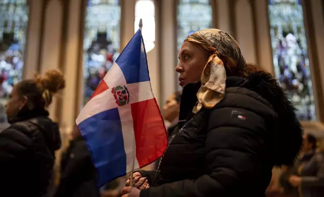 People attend a Mass for the victims of the Jet Set club roof collapse at St. Elizabeth's Church, Wednesday, April 9, 2025 in New York. (AP Photo/Adam Gray)