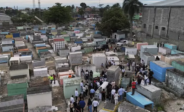 Family and friends attend the burial service for Marilenny Pilarte who died at the Jet Set nightclub when its roof collapsed, in Haina, Dominican Republic, Thursday, April 10, 2025. (AP Photo/Matias Delacroix)