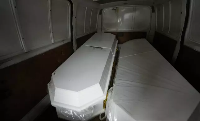 The coffin on the left that contains the remains of a son of Carlos Severino, sits next to an empty coffin that will be used for the remains of another son of Severino, who lost three sons when the Jet Set nightclub roof collapsed, outside the morgue of the National Institute of Forensic Pathology in Santo Domingo, Dominican Republic, Friday, April 11, 2025. (AP Photo/Matias Delacroix)