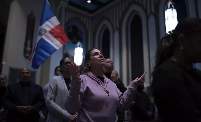 People attend a Mass for the victims of the Jet Set club roof collapse at St. Elizabeth's Church, Wednesday, April 9, 2025 in New York. (AP Photo/Adam Gray)