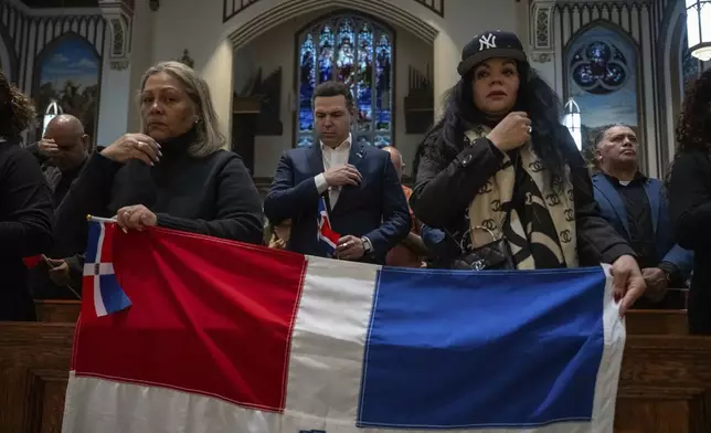 People attend a Mass for the victims of the Jet Set club roof collapse at St. Elizabeth's Church, Wednesday, April 9, 2025 in New York. (AP Photo/Adam Gray)