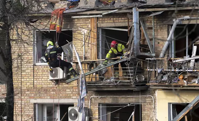 Rescue workers clear the rubble from a house heavily damaged after a Russian strike in a residential neighborhood in Kyiv, Ukraine, Thursday, April 24, 2025. (AP Photo/Alex Babenko)