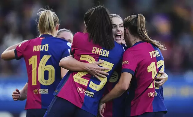 Barcelona's Alexia Putellas, 2nd right, celebrates with teammates Ingrid Syrstad Engen and Patri Guijarro, right, after defeating Chelsea 4-1 in their women's Champions League semifinals, first leg, soccer match at the Johan Cruyff Stadium, in Sant Joan Despi, outside Barcelona, Spain, Sunday, April 20, 2025. (AP Photo/Bagu Blanco)