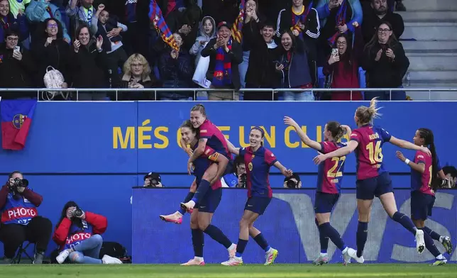 Barcelona's Claudia Pina celebrates on the shoulders of Alexia Putellas, left, after scoring her side's fourth goal during the women's Champions League semifinals, first leg, soccer match between FC Barcelona and Chelsea FC at the Johan Cruyff Stadium, in Sant Joan Despi, outside Barcelona, Spain, Sunday, April 20, 2025. (AP Photo/Bagu Blanco)