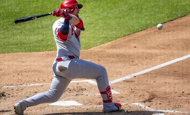 St. Louis Cardinals' Nolan Gorman (16) hits the ball and flies out to center during the fourth inning of a baseball game against the New York Mets, Sunday, April 20, 2025, in New York. (AP Photo/Angelina Katsanis)
