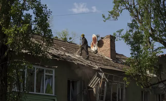 A rescue worker clears the rubble of a house damaged by a Russian strike on a residential neighbourhood in Kyiv, Ukraine, on Thursday, April 24, 2025. (AP Photo/Evgeniy Maloletka)