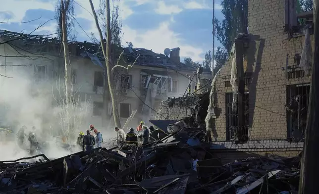 Rescue workers clear the rubble after a Russian ballistic missile attack in Kyiv, Ukraine, Thursday, April 24, 2025. (AP Photo/Efrem Lukatsky)