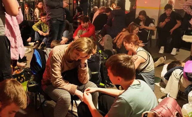 People rest in a metro station, being used as a bomb shelter, during a Russian missile attack in Kyiv, Ukraine, early Thursday, April 24, 2025. (AP Photo/Efrem Lukatsky)