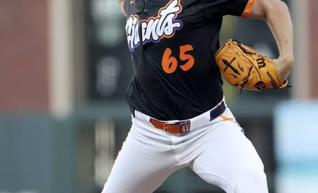 San Francisco Giants starting pitcher Landen Roupp (65) throws a pitch in the first inning of a baseball game against the Cincinnati Reds in San Francisco, Tuesday, April 8, 2025. (AP Photo/Scot Tucker)
