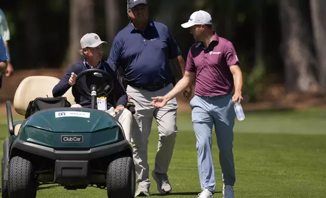 Justin Thomas speaks with an official from the second fairway during the third round of the RBC Heritage golf tournament, Saturday, April 19, 2025, in Hilton Head Island, S.C. (AP Photo/Mike Stewart)