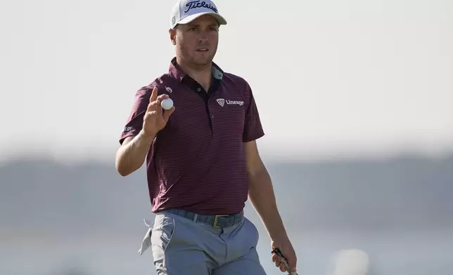 Justin Thomas departs the 18th green during the third round of the RBC Heritage golf tournament, Saturday, April 19, 2025, in Hilton Head Island, S.C. (AP Photo/Mike Stewart)