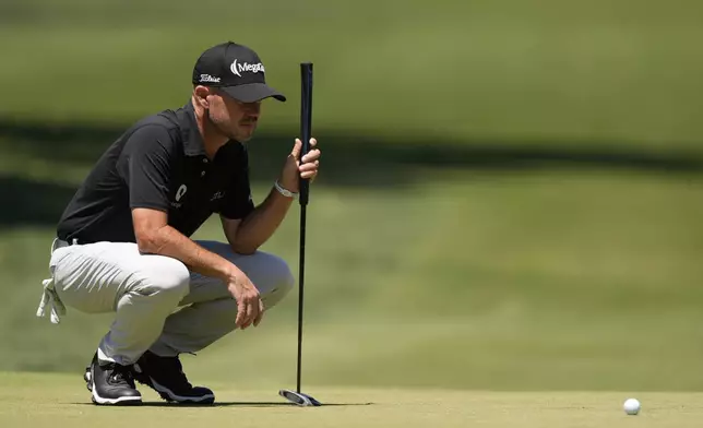 Brian Harman lines up a putt on the second hole during the third round of the RBC Heritage golf tournament, Saturday, April 19, 2025, in Hilton Head Island, S.C. (AP Photo/Mike Stewart)