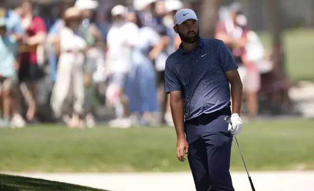 Scottie Scheffler watches his shot from the bunker on the second hole during the third round of the RBC Heritage golf tournament, Saturday, April 19, 2025, in Hilton Head Island, S.C. (AP Photo/Mike Stewart)