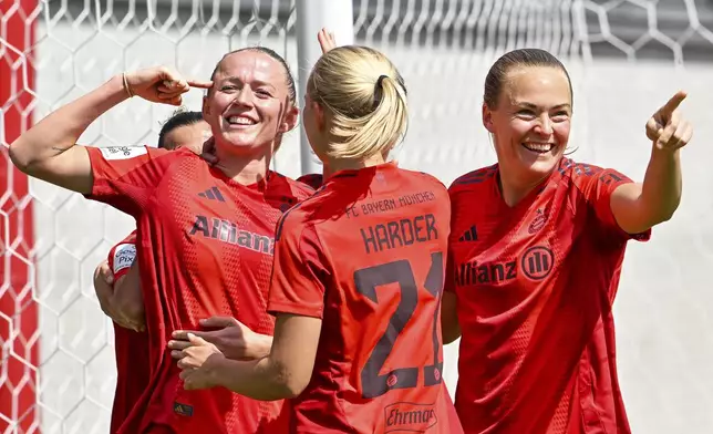 Bayern Munich players celebrate after a goal during a Women's Bundesliga soccer match against SC Freiburg in Munich, Germany, Sunday, April 27, 2025. (Peter Kneffel/dpa via AP)